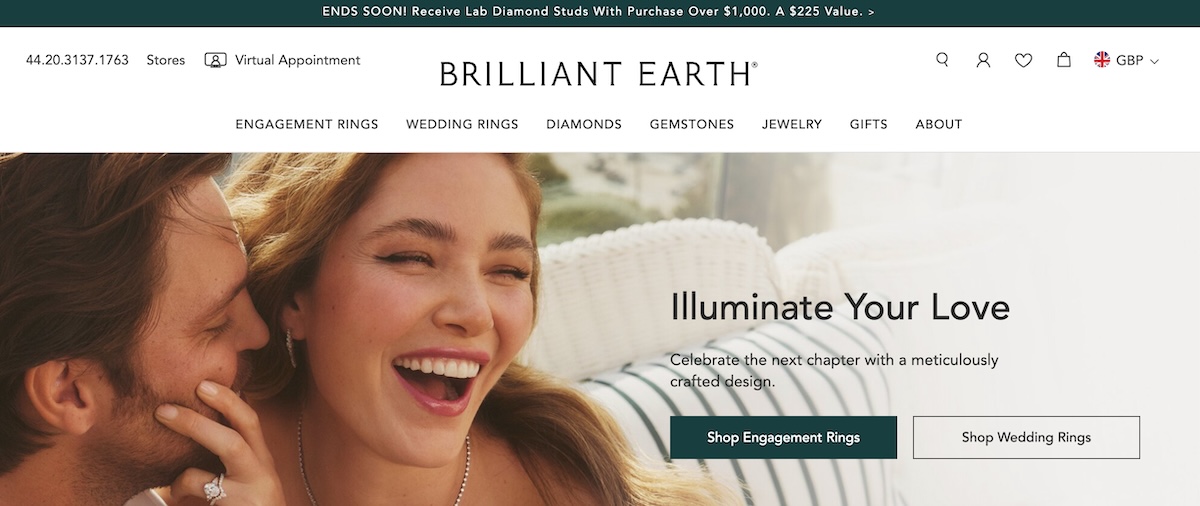 Brilliant Earth's homepage showing an engaging couple and promotional message about lab diamond studs with navigation to various jewelry sections.